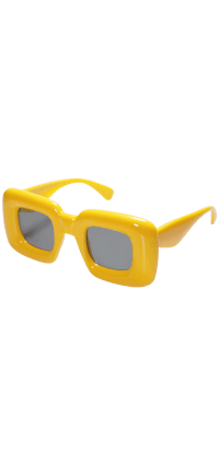 a pair of yellow sunglasses on a black background
